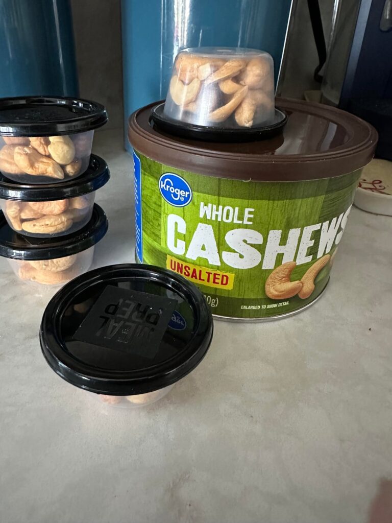 Making portion cups of cashews for snack time.