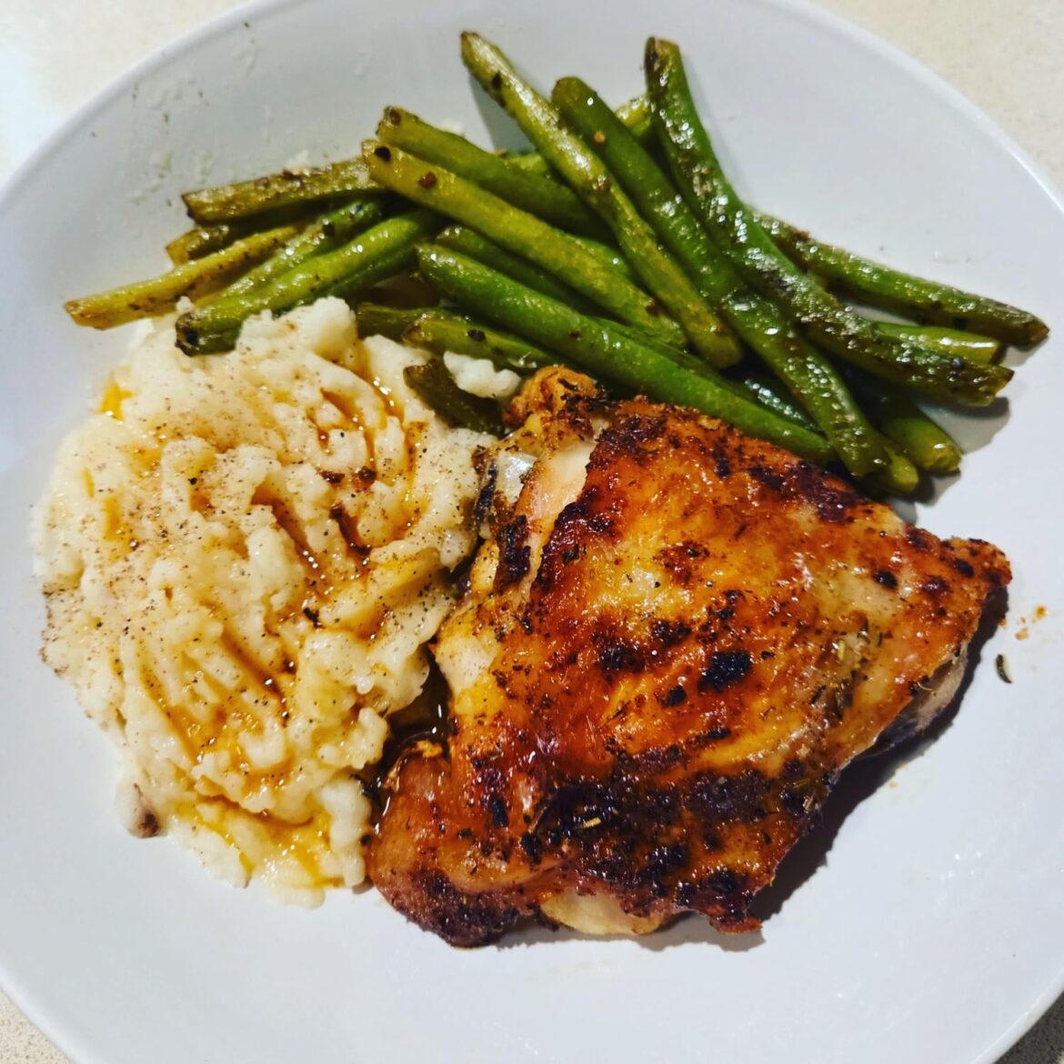 Chicken, mash, garlicky sautéed green beans, and pan juice.
