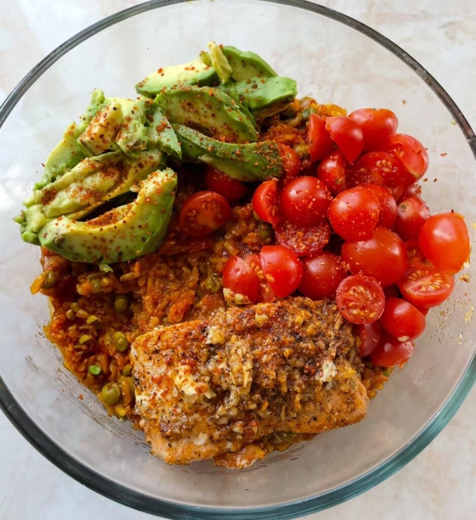Tomato brown rice, baked salmon, cherry tomatoes and avocado. 🥑