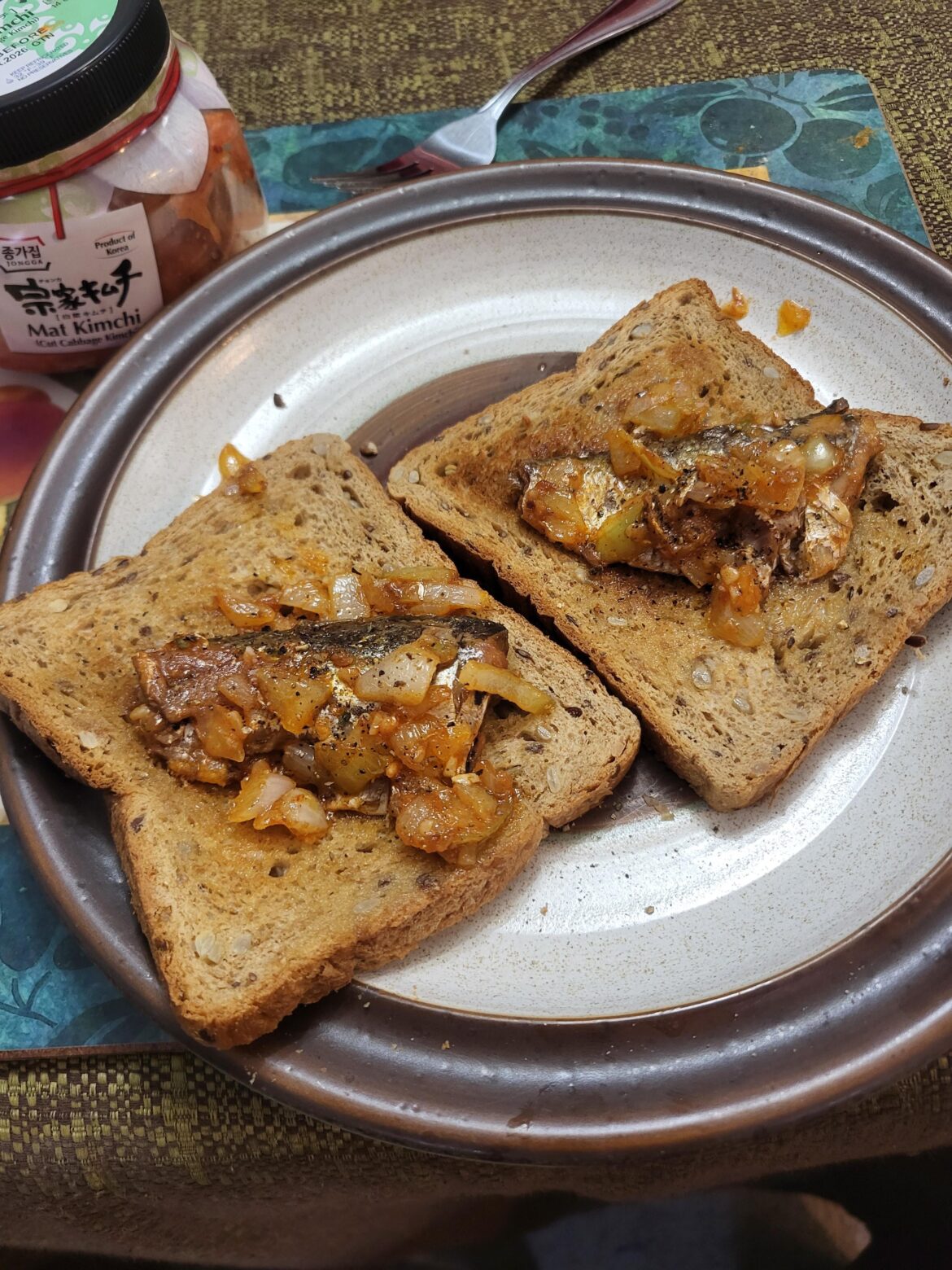 My highest-effort depression meal in months: tomato sardines fried with onions and garlic, with a side of kimchi. My breath is lethal.
