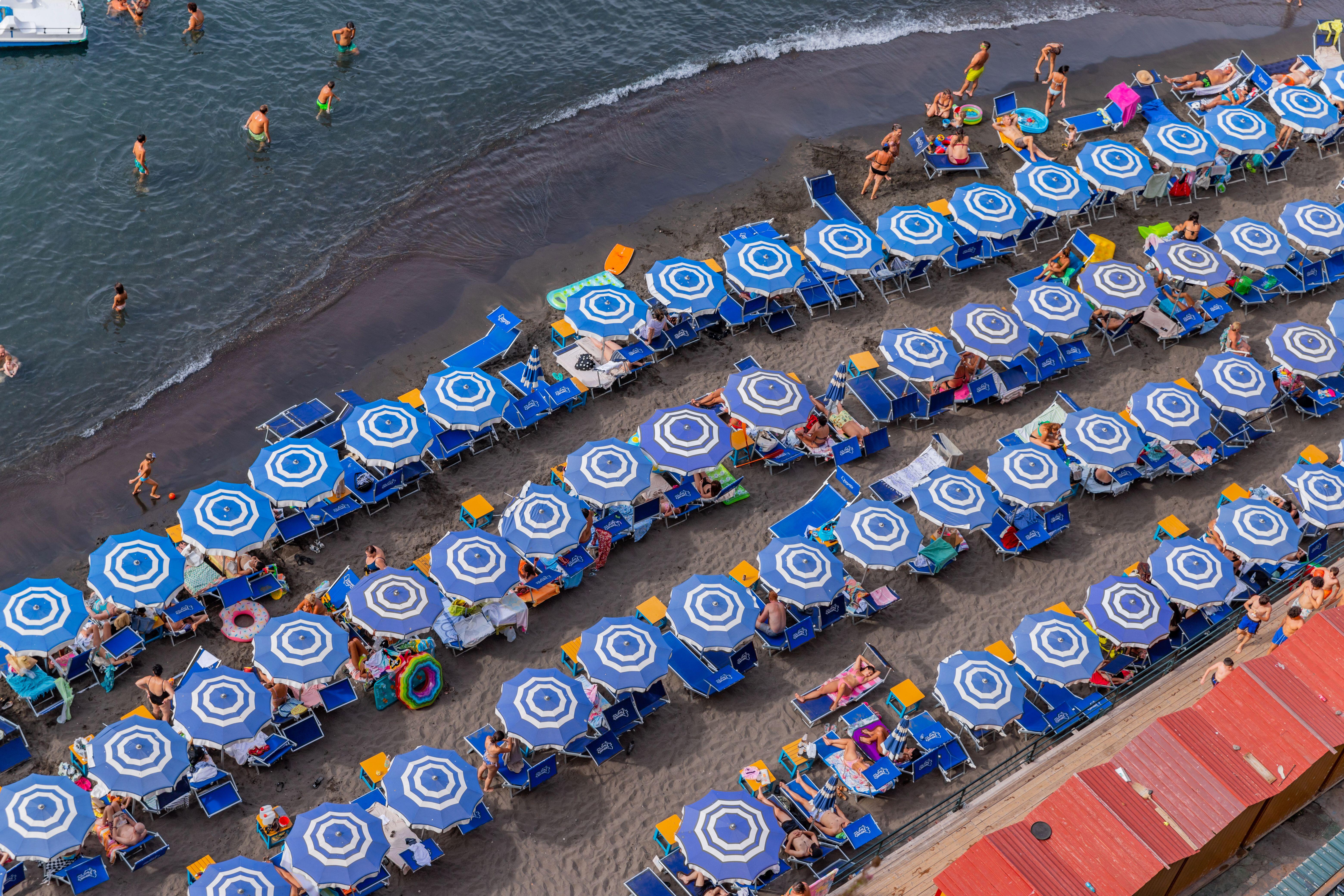 Beach club with umbrellas and lounge chairs.