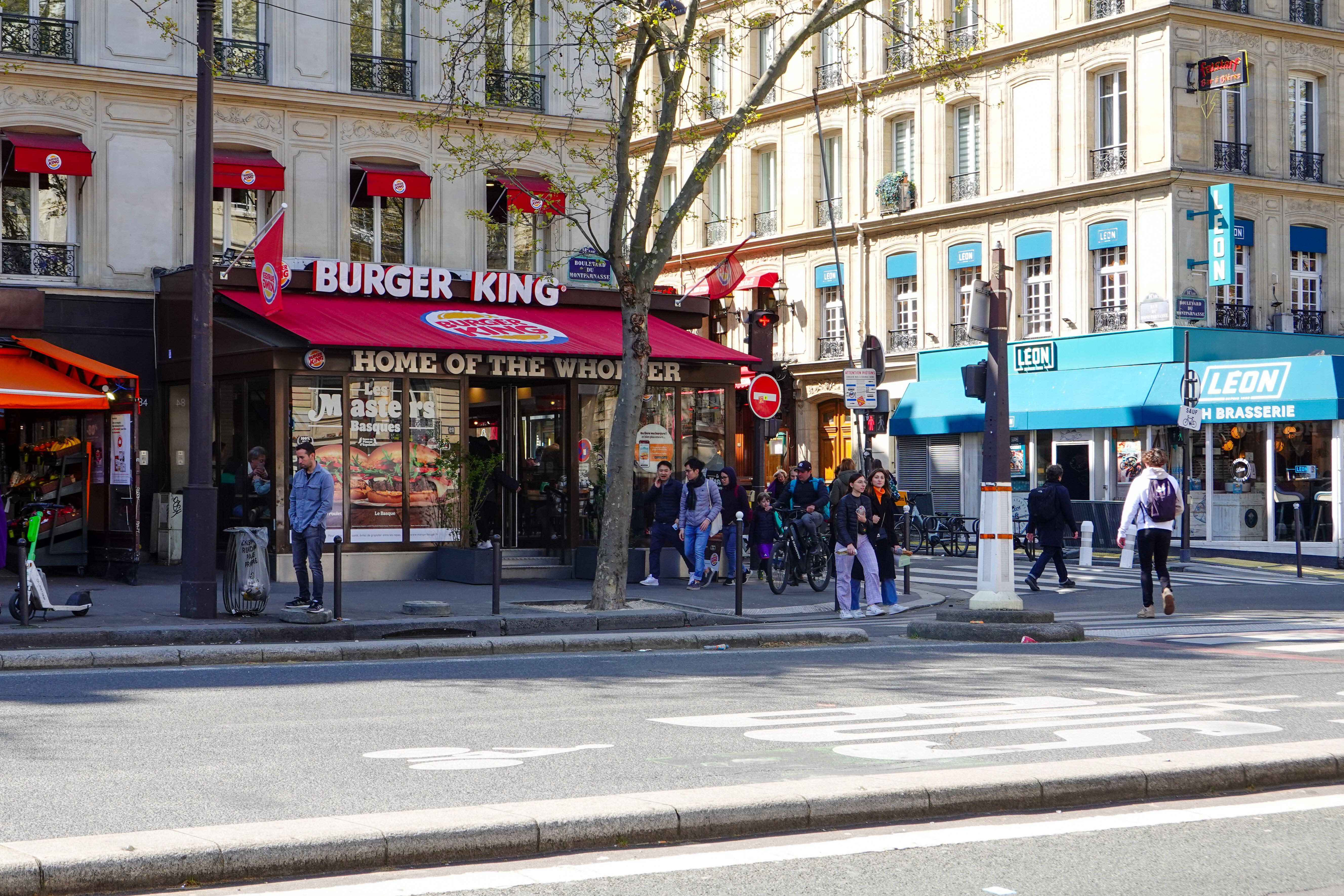 People walking past a Burger King in Paris.