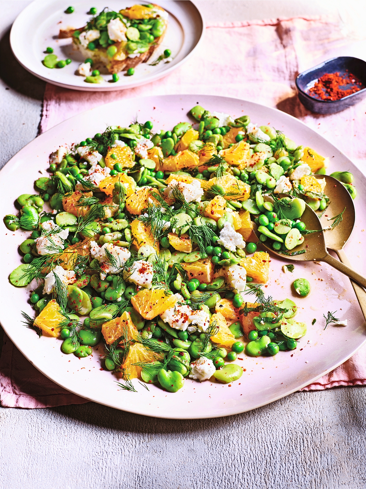 Broad bean, pea, and orange salad with feta cheese and dill.