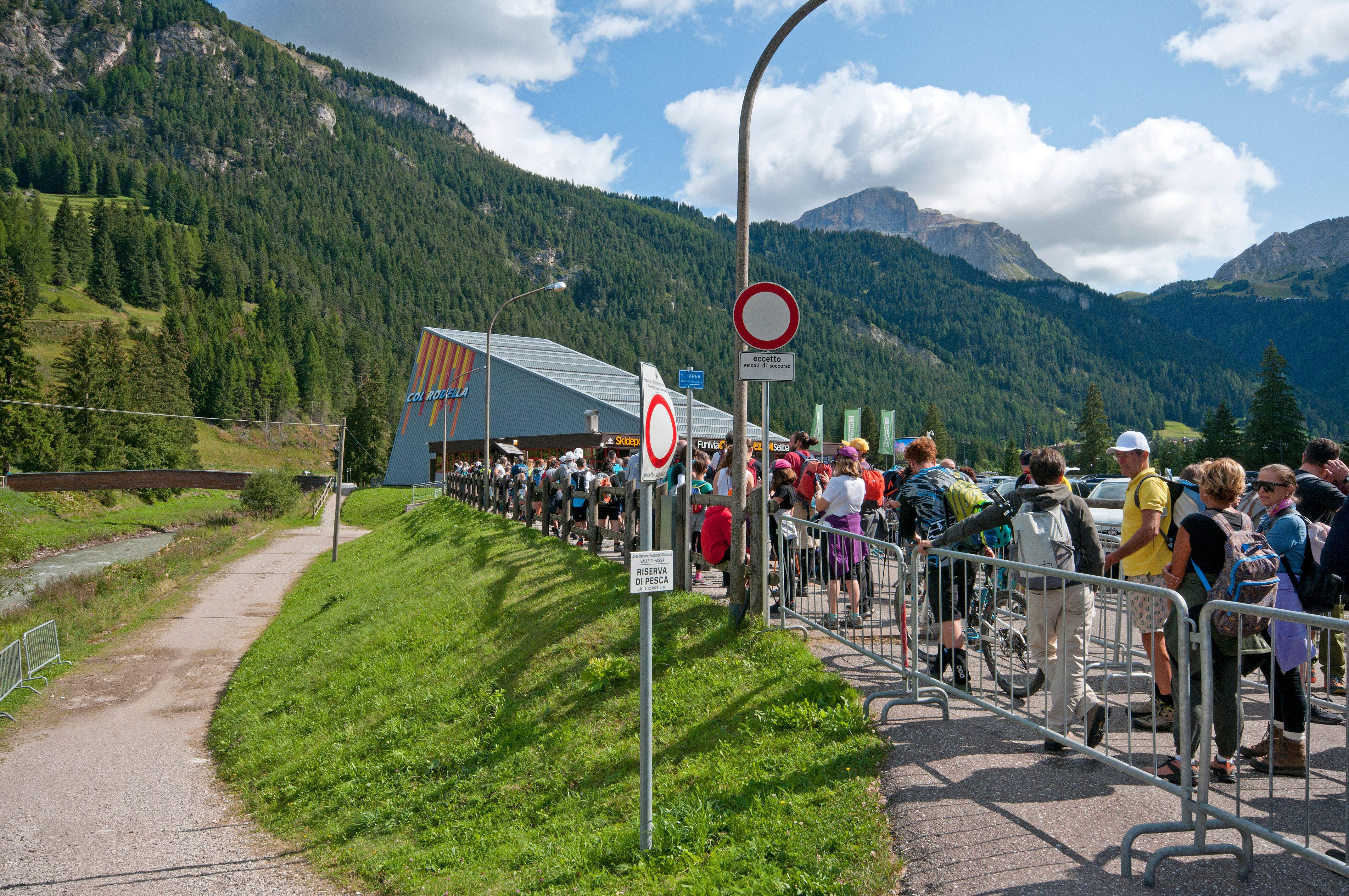 Tourists queueing for a cable car in the mountains.