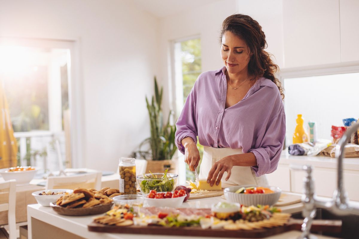 A woman is preparing food in the kitchen