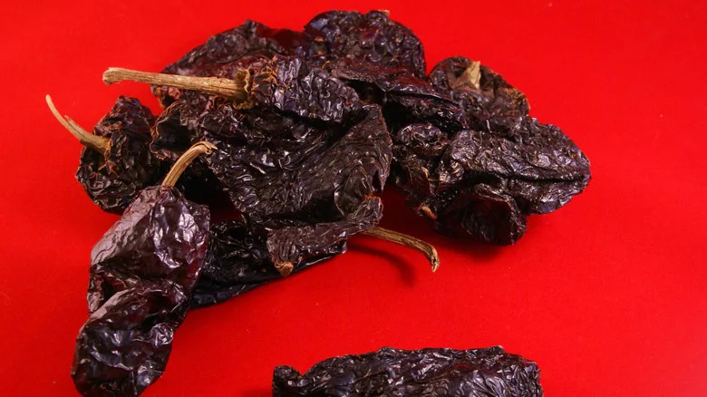 Ancho chiles on a red background