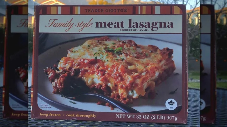 Trader Joe's family style frozen meat lasagna in box on metal table.