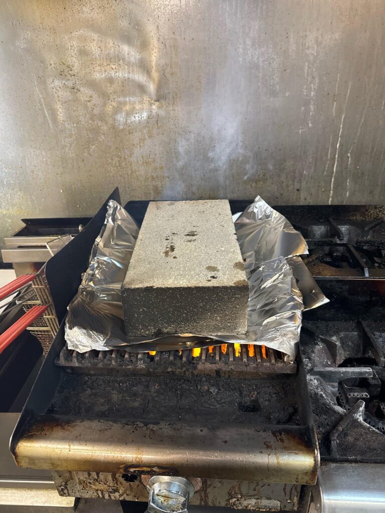 Boss insists this is a safe way to burn/clean the grill, is burning foil like this ok?