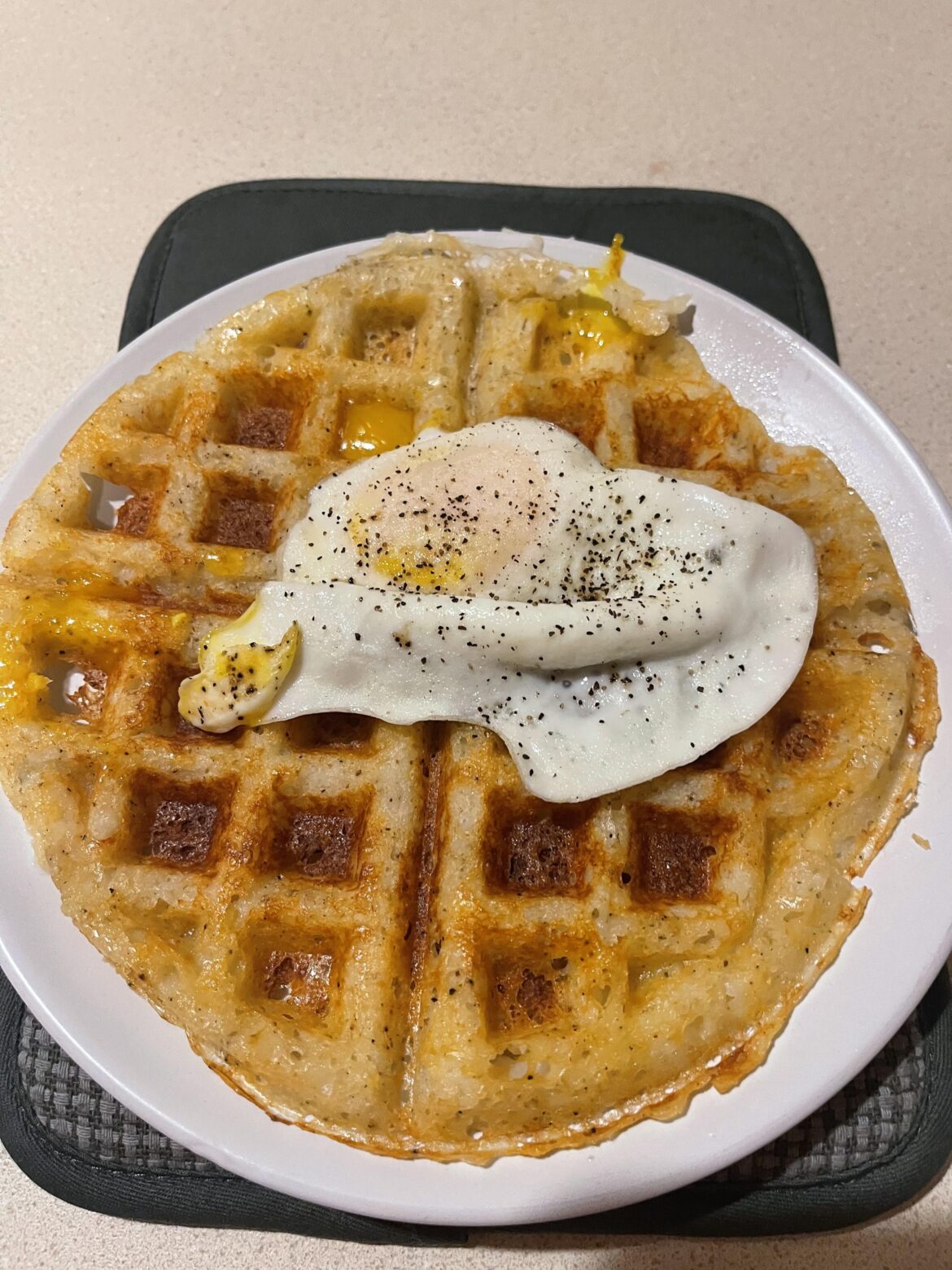 Leftover mashed potato and cheese waffle with over medium egg