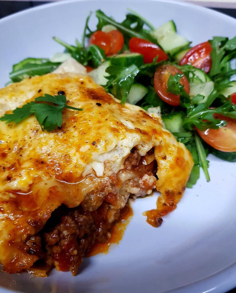 Sunday Homemade Lasagna. Topped with an Egg Bechemel and Three Cheeses. Simple Salad Side.