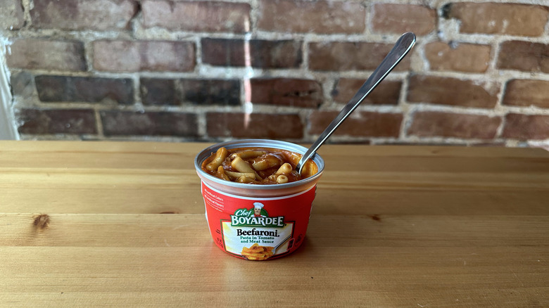 Beefaroni with spoon on wooden table