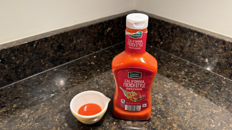 California French-Style dressing on countertop next to small white dish containing dressing