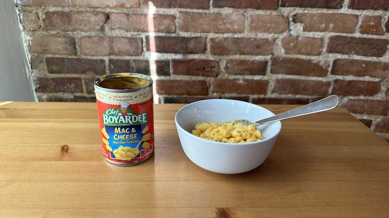 Mac and Cheese with spoon on wooden table