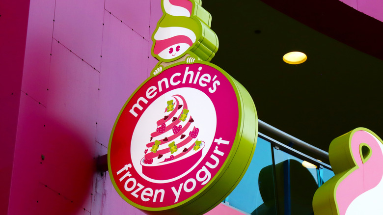 Pink Menchie's Frozen Yogurt sign on building
