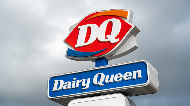 Dairy Queen sign against cloudy sky