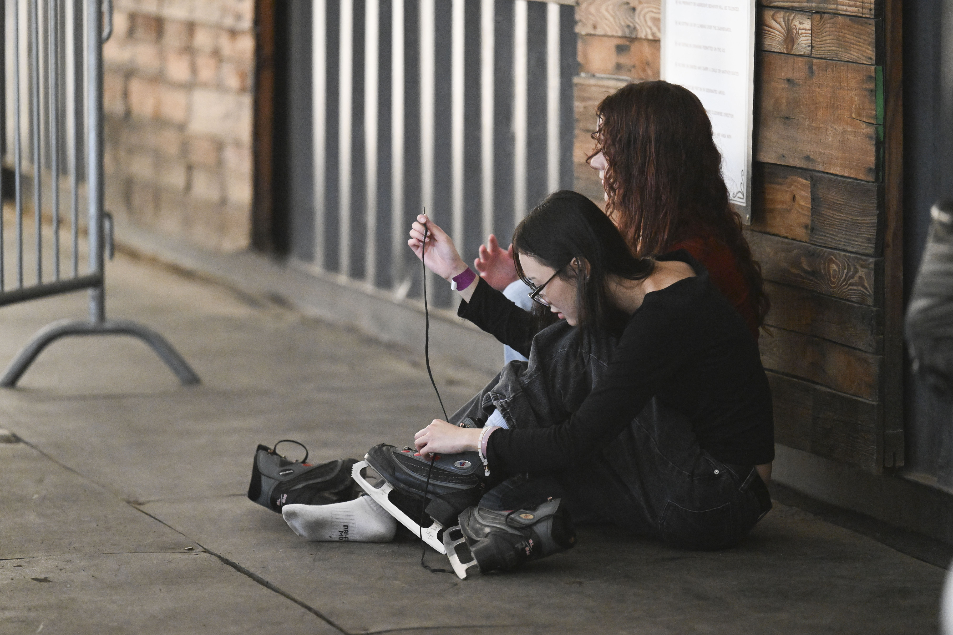 Visitors tie their ice skates at Peltzer Winery ice rink...