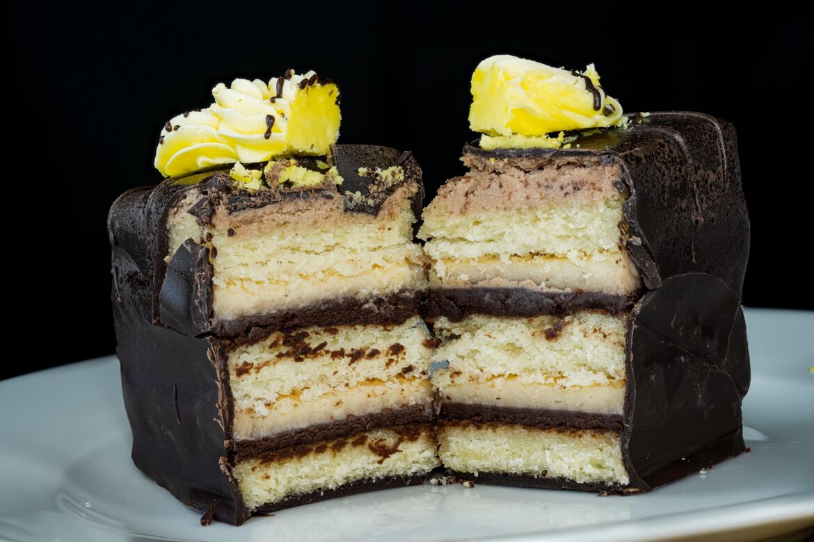Boston cream pie, it’s yellow butter cake with vanilla custard, chocolate ganache, and dipped in chocolate!