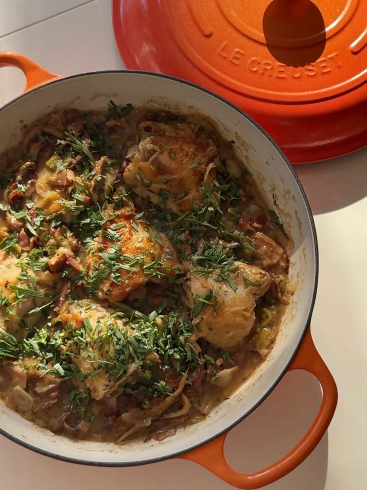 Overhead closeup on a baking dish with cooked chicken thighs 