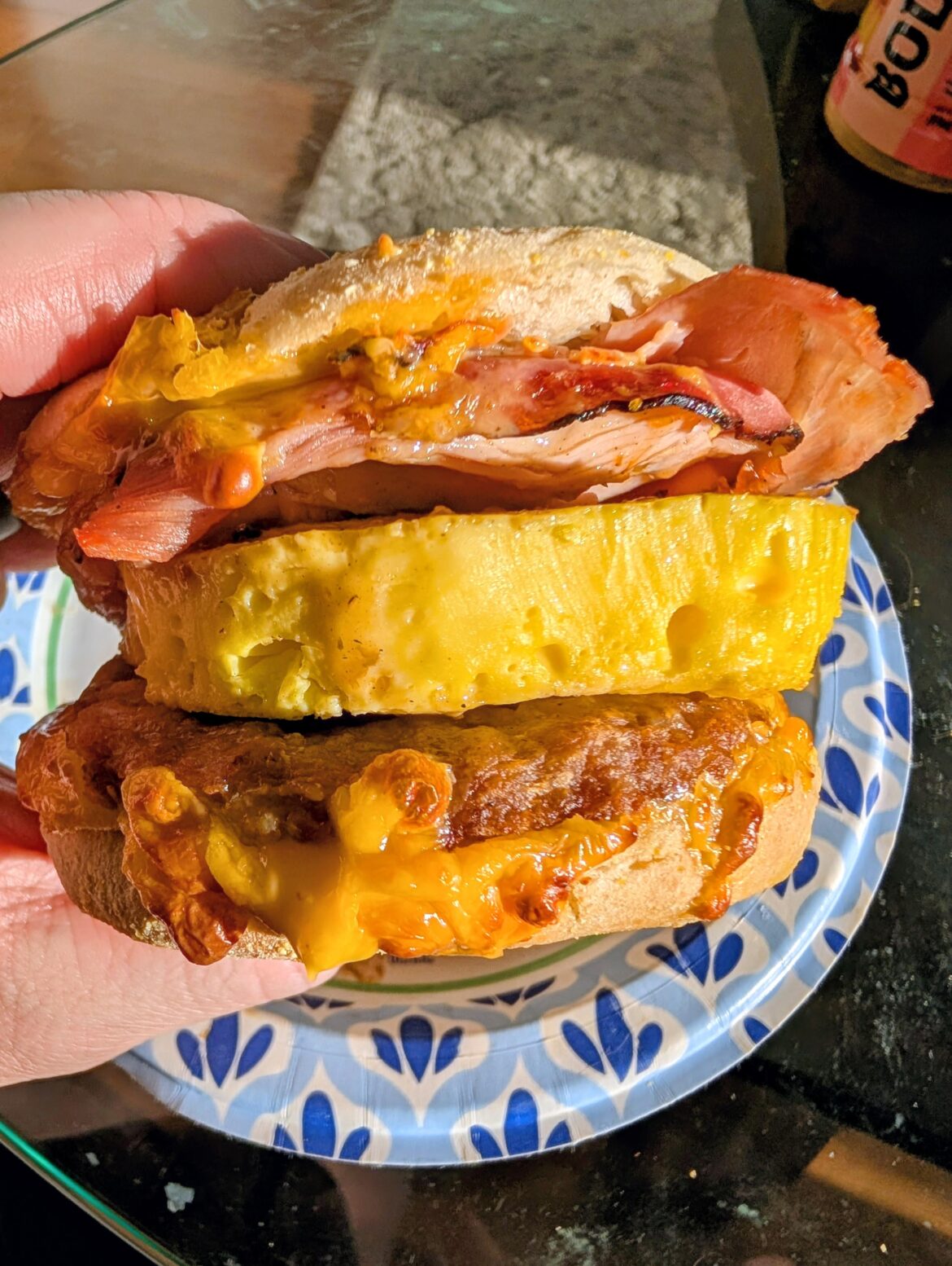 Sausage, ham, egg, and American cheese on a toasted English muffin