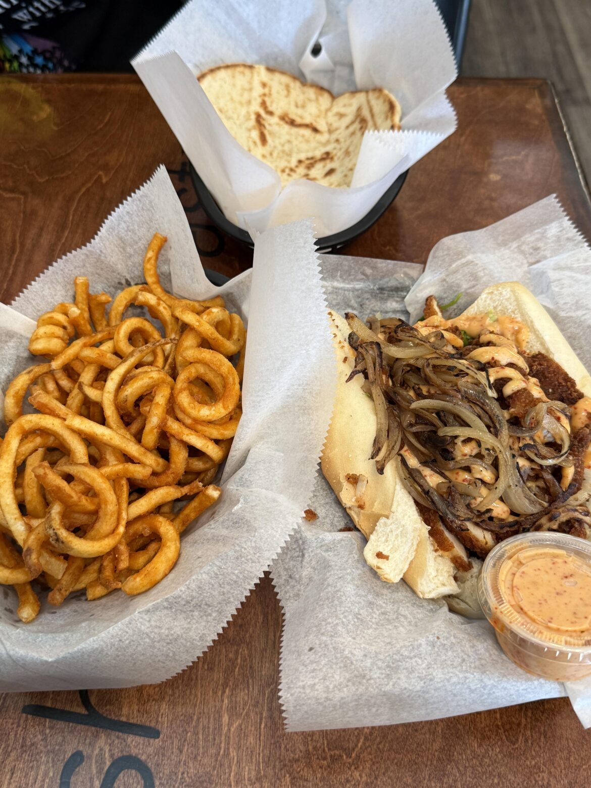 Slims on Montrose. Chicken po boy w/ grilled onions and curly fries