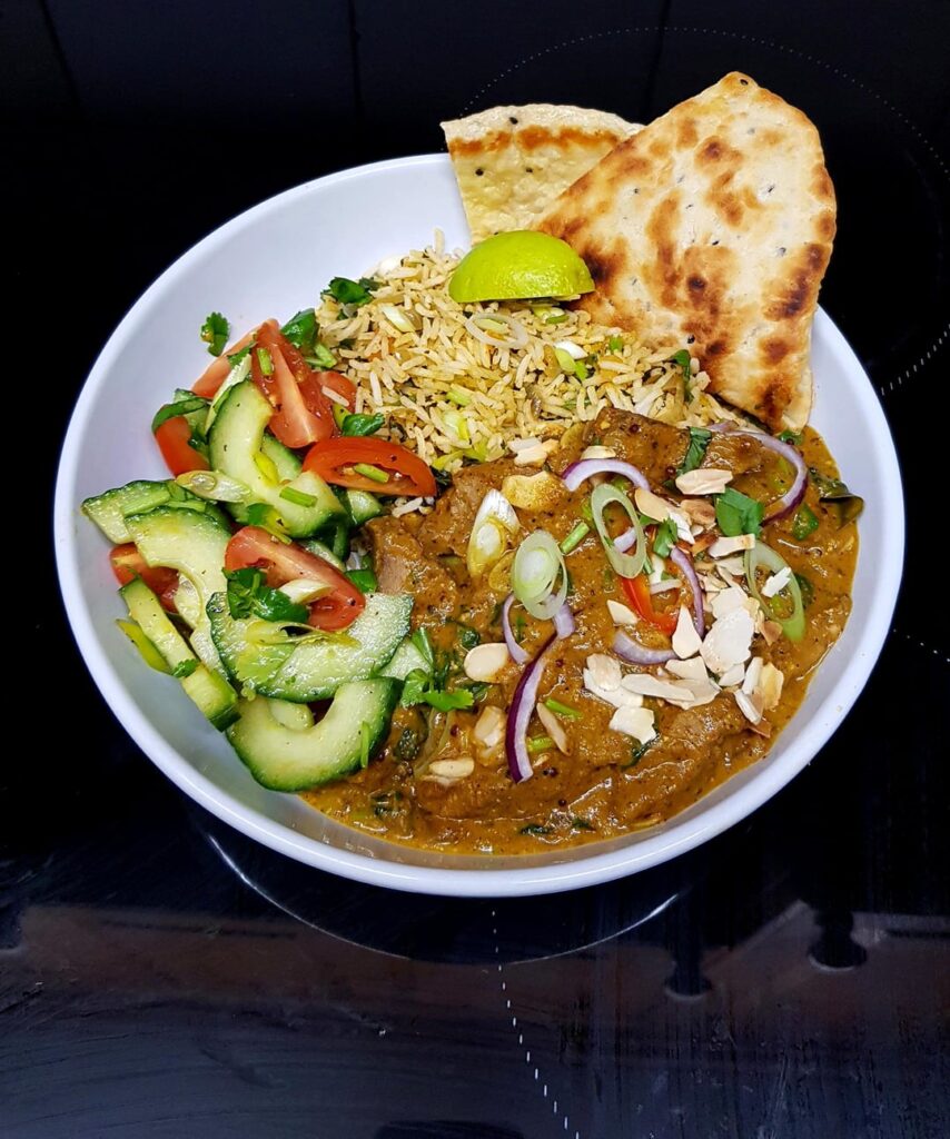 Almond and Coconut Lamb Curry (Similar to Pasanda), Spinach and Tomato Rice, Cucumber Salad and Homemade Naan. Finished with Toasted Almonds and Herbs.