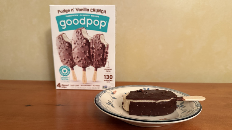 Fudge n' vanilla crunch pop on plate in front of box