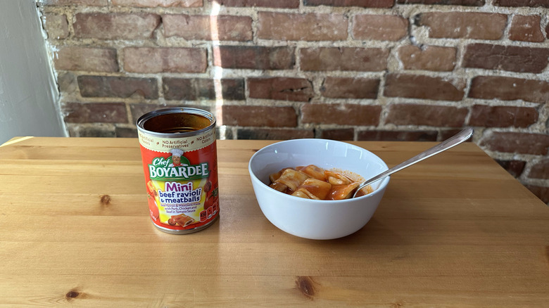 Mini Beef Ravioli and Meatballs with spoon on wooden table
