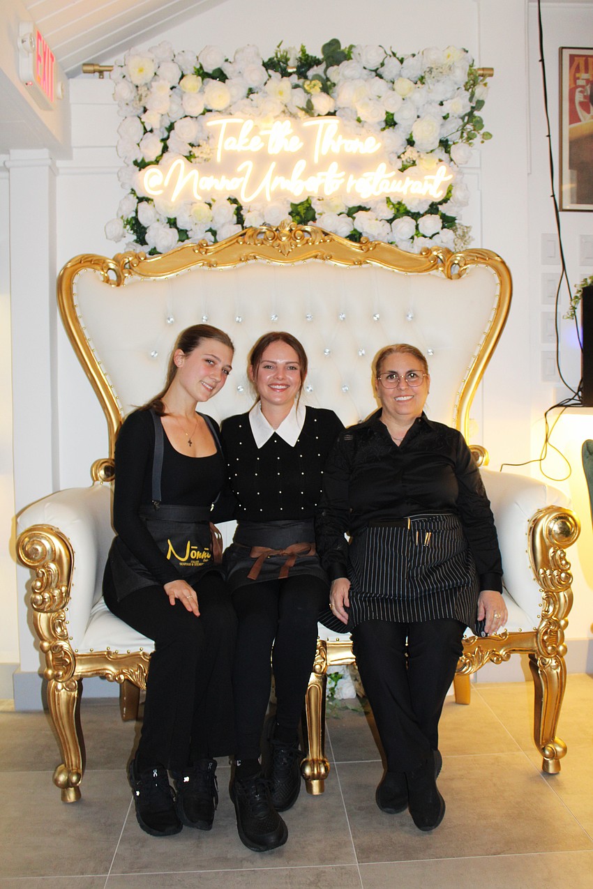 Lucy Vigrass, Amber Mayner and Debora Mucci try out the golden throne photo opportunity at the newly opened Nōnnō Umberto Italian restaurant on St. Armands Circle.