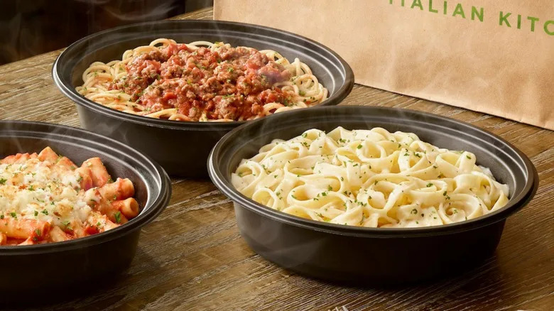 Olive Garden food sits plated on a wooden table