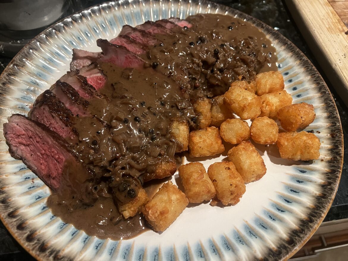 Steak frites au poivre, except with tater tots