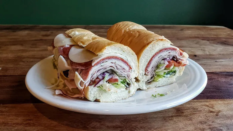 The 5 Meat Italian from Subway, plated, on a wood table.