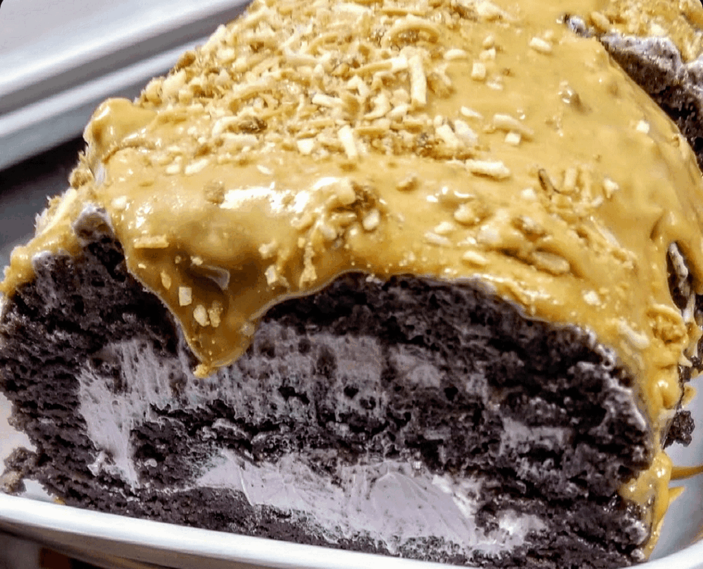 Ube Roll Cake filled w/ Ube cream, topped with Dulce De Leche and toasted Coconut