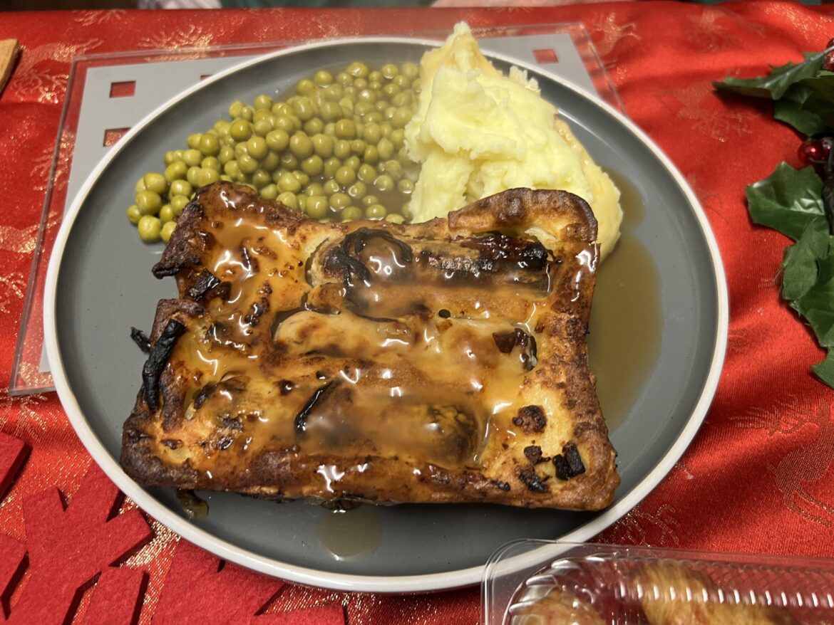 Homemade Toad in the Hole with baked in onions, peas and mash
