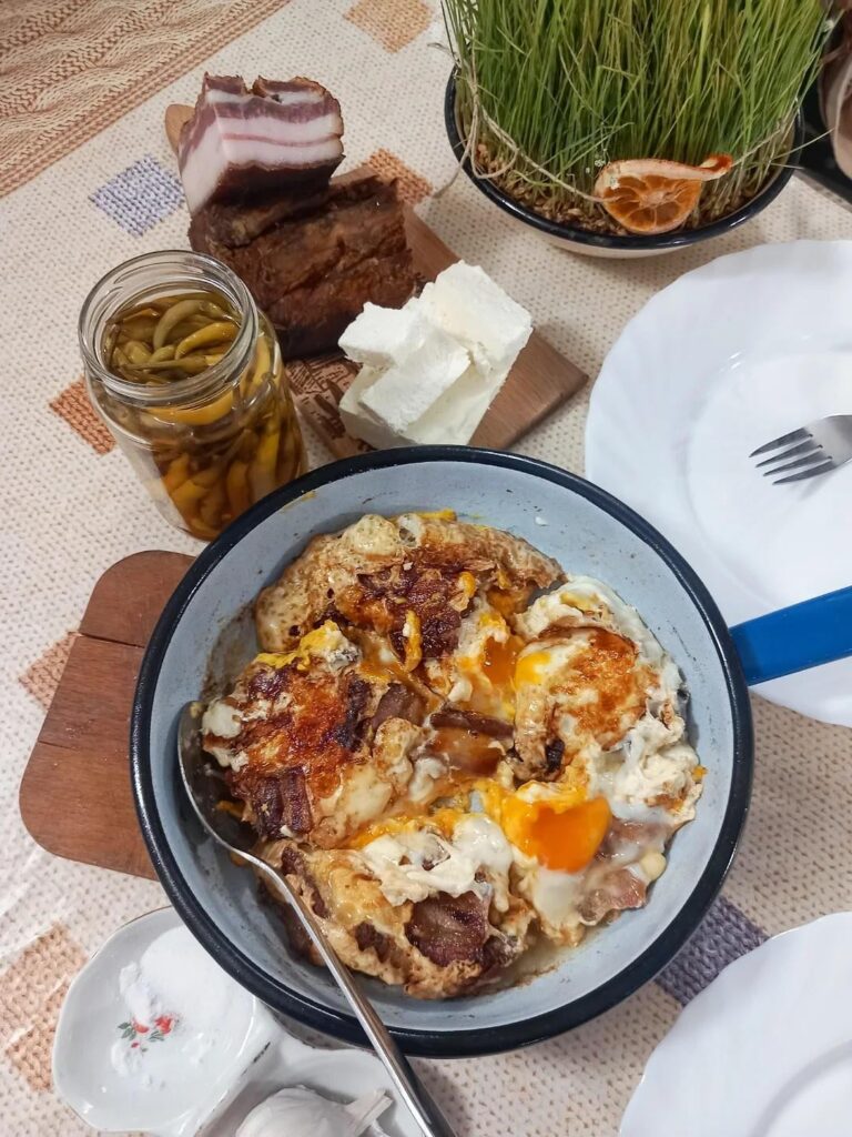 Breakfast in Serbia - scrambled eggs, bacon, cheese, pfefferoni, garlic