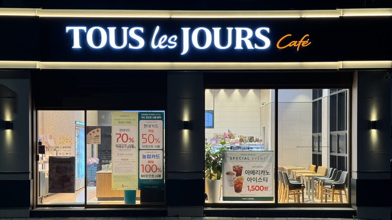 Tous Les Jours cafe lit up at night