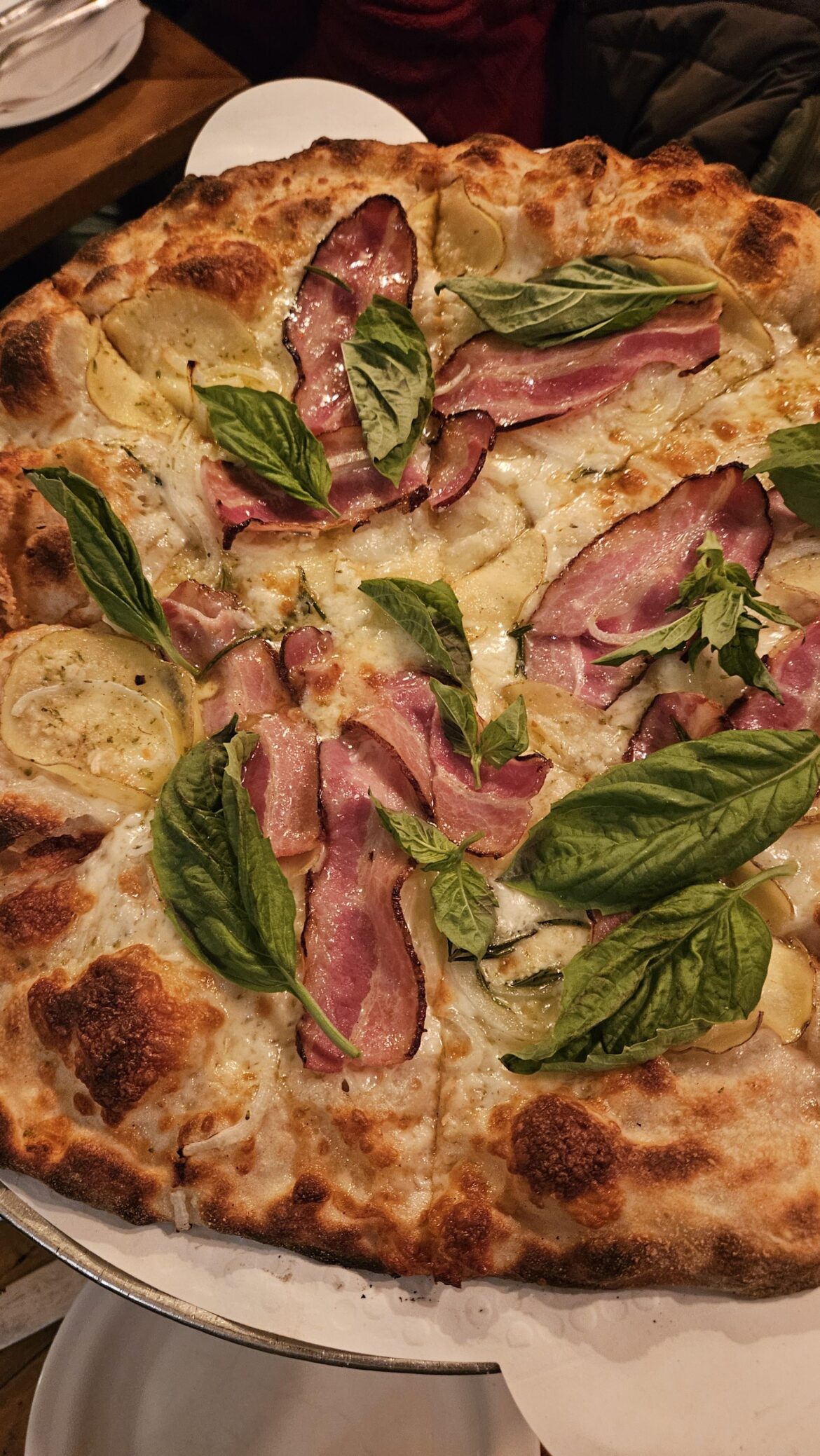 New Haven-style pizza pie with potatoes, onions, basil, rosemary and bacon from Wheated in Brooklyn