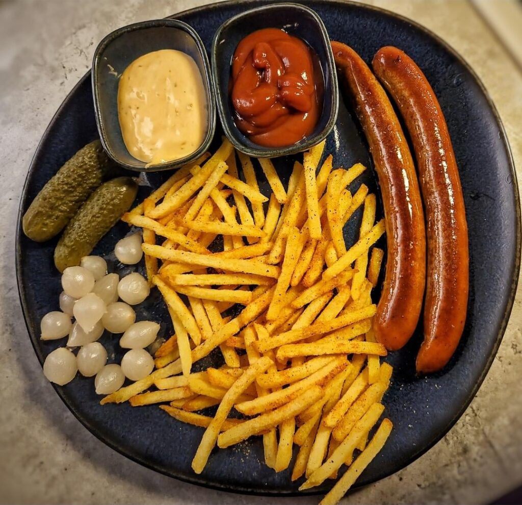 Spicy sausages, chips, cheese & jalapeño sauce, ketchup and some pickled goodness