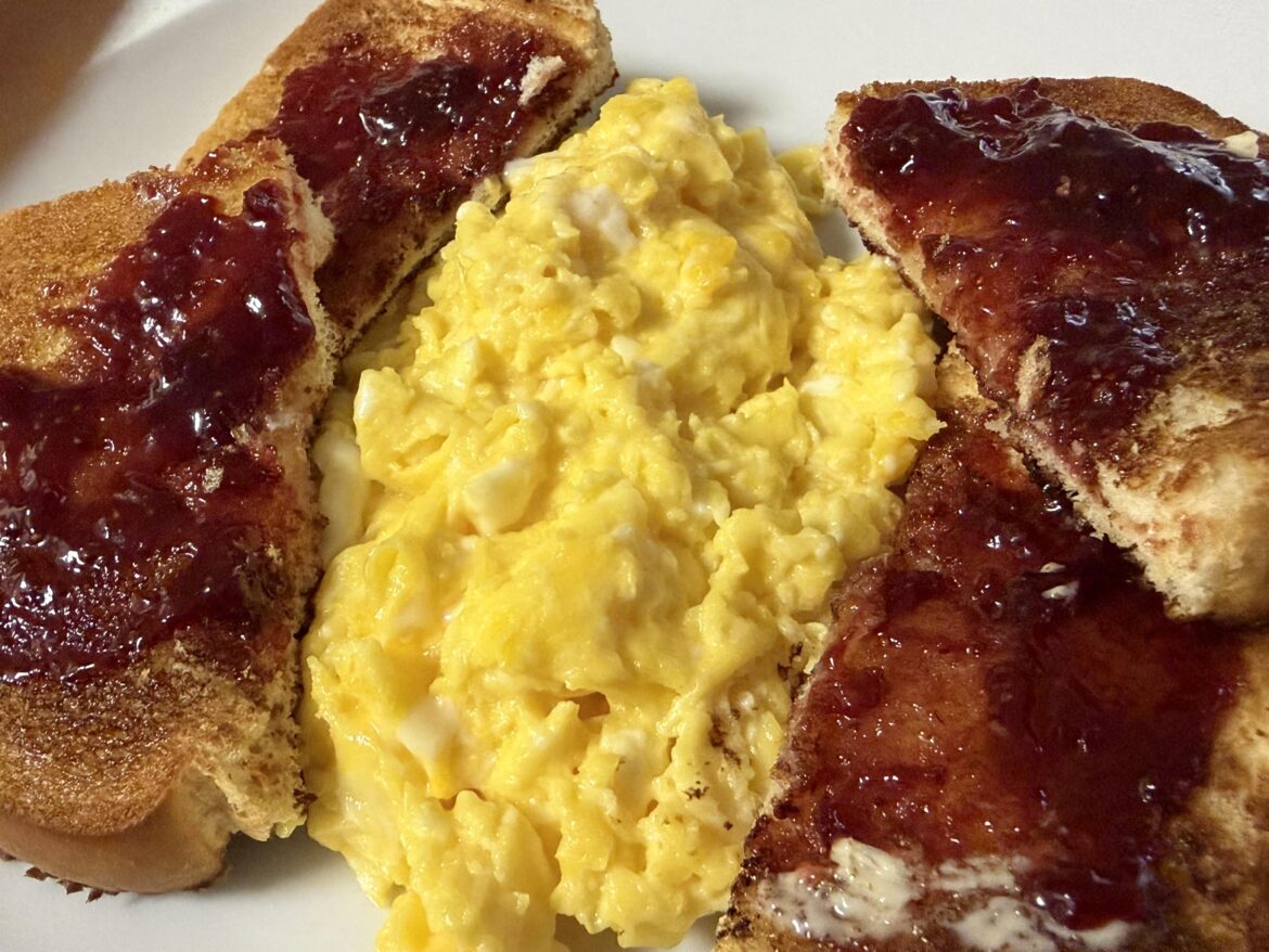 Scrambled eggs, toast with butter and jam.