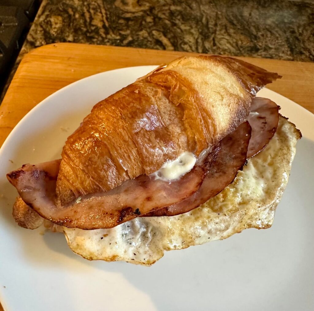 Fried Ham & Egg, Bacon, and NM Green Chile on Toasted Croissant