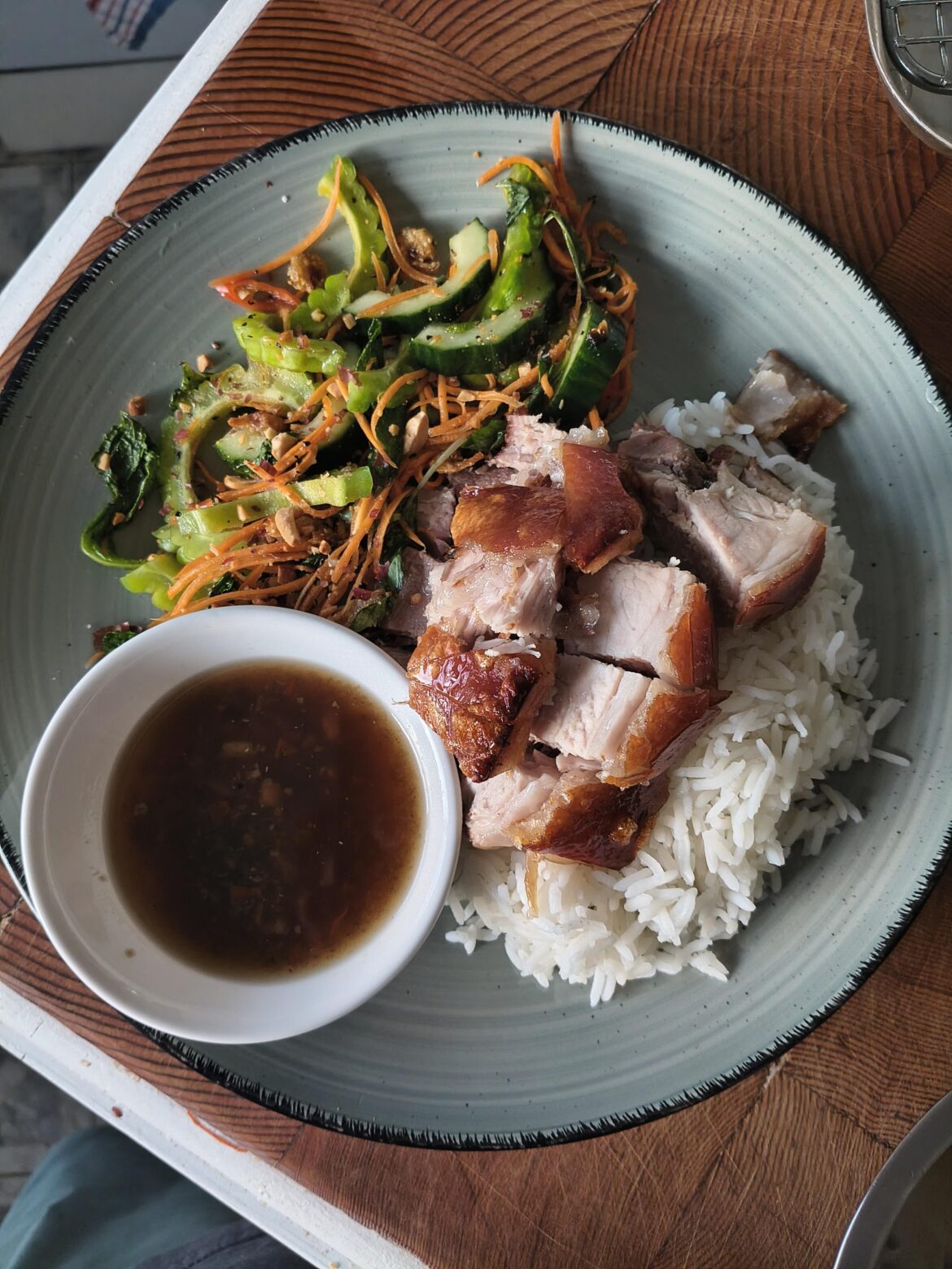 Crispy pork shoulder, steamed white rice and bitter melon salad.