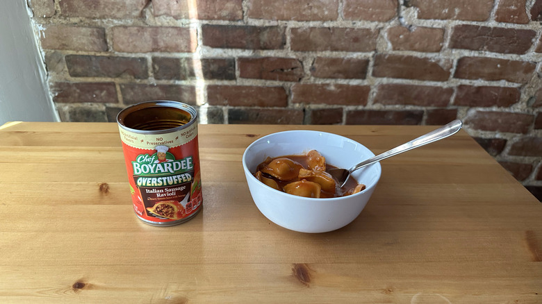 Overstuffed Italian Sausage Ravioli with spoon on wooden table