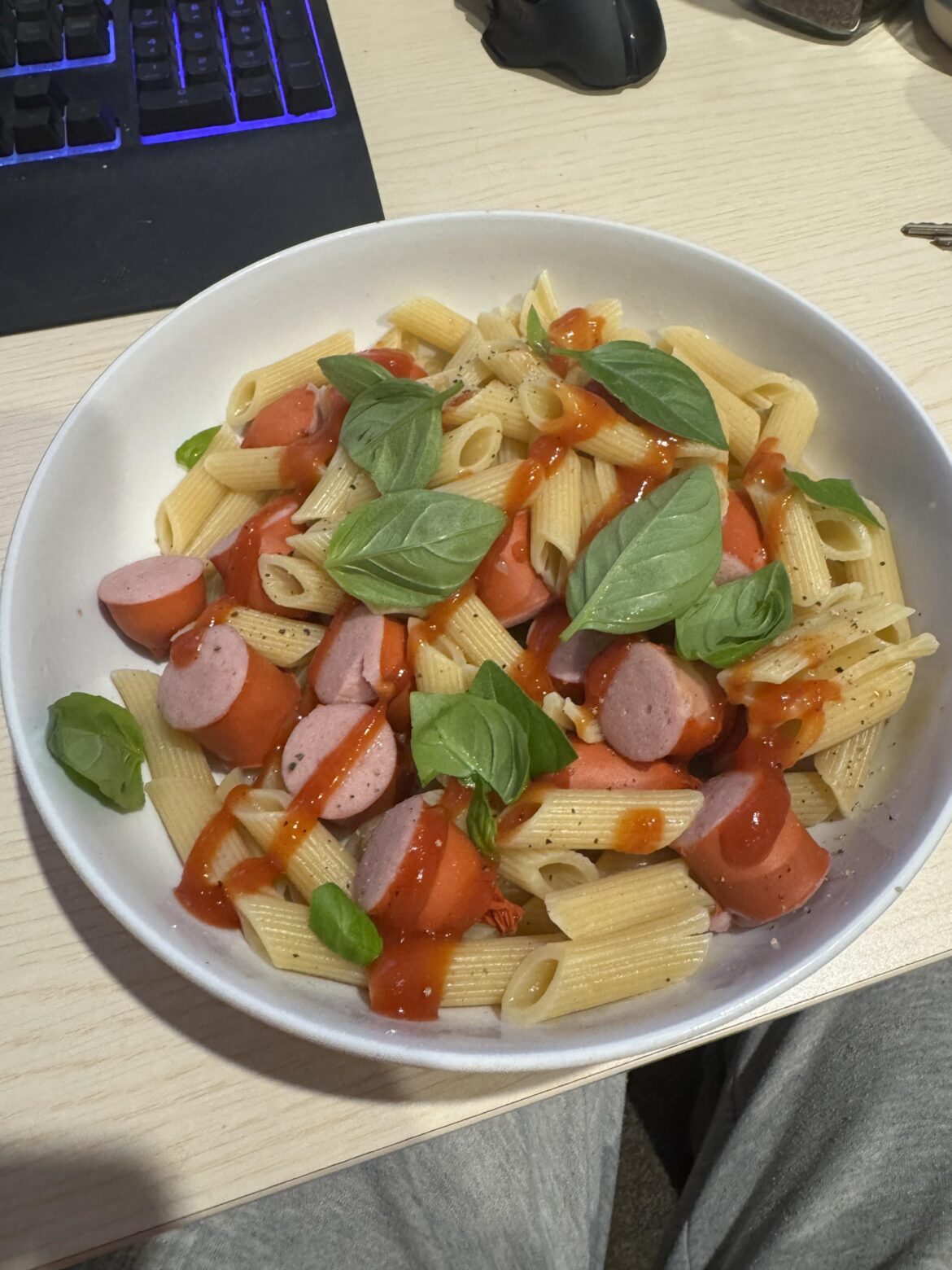 Penne hotdog with ketchup and fresh basil