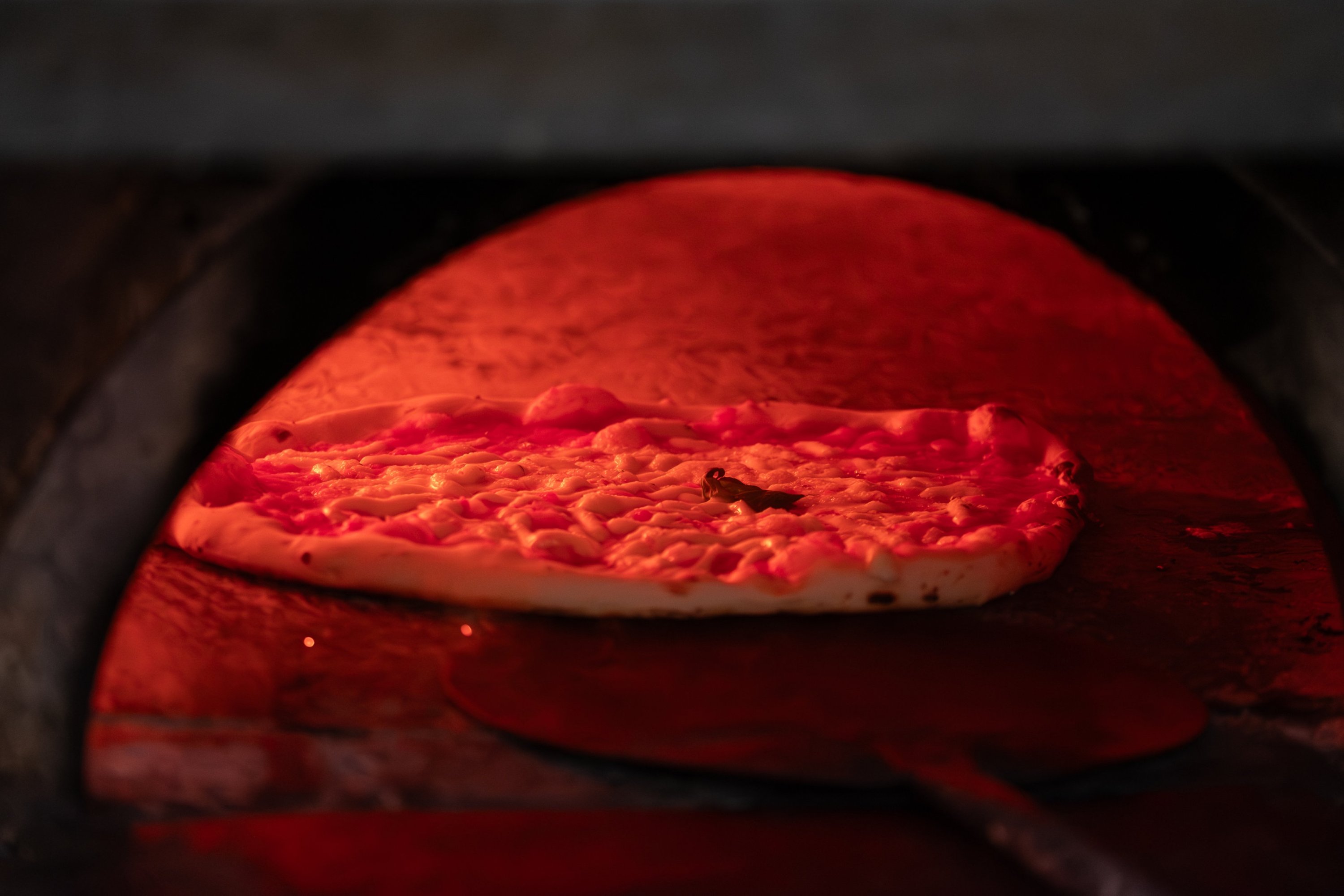A pizza cooks in a wood-fired oven, Rome, Italy, Jan. 13, 2025. (AA Photo)