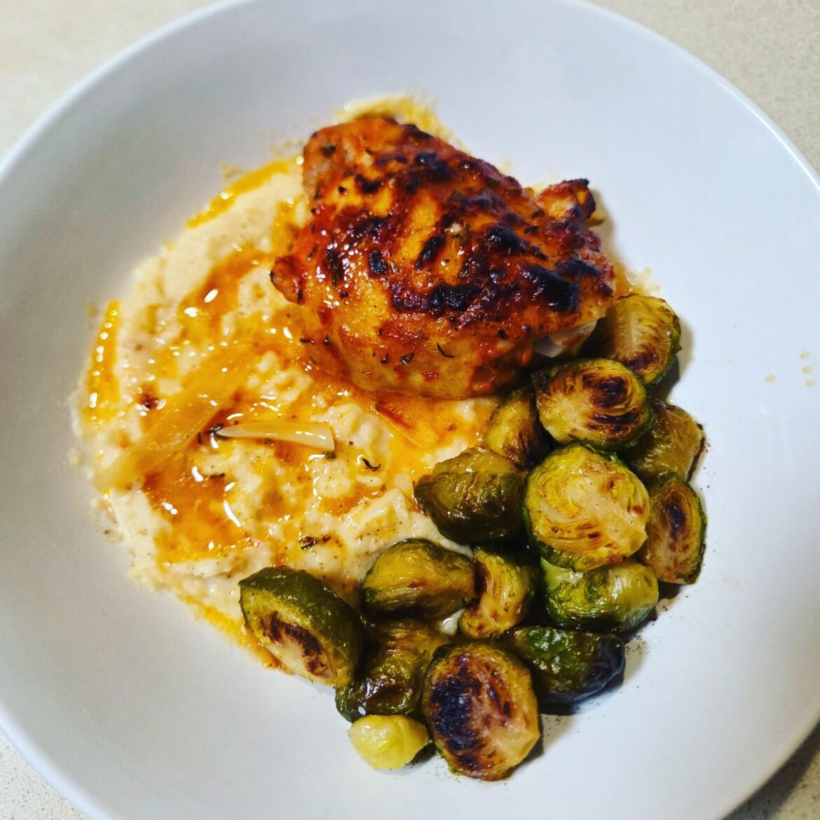 Baked chicken and shallots with potato casserole, and roasted brussel sprouts.