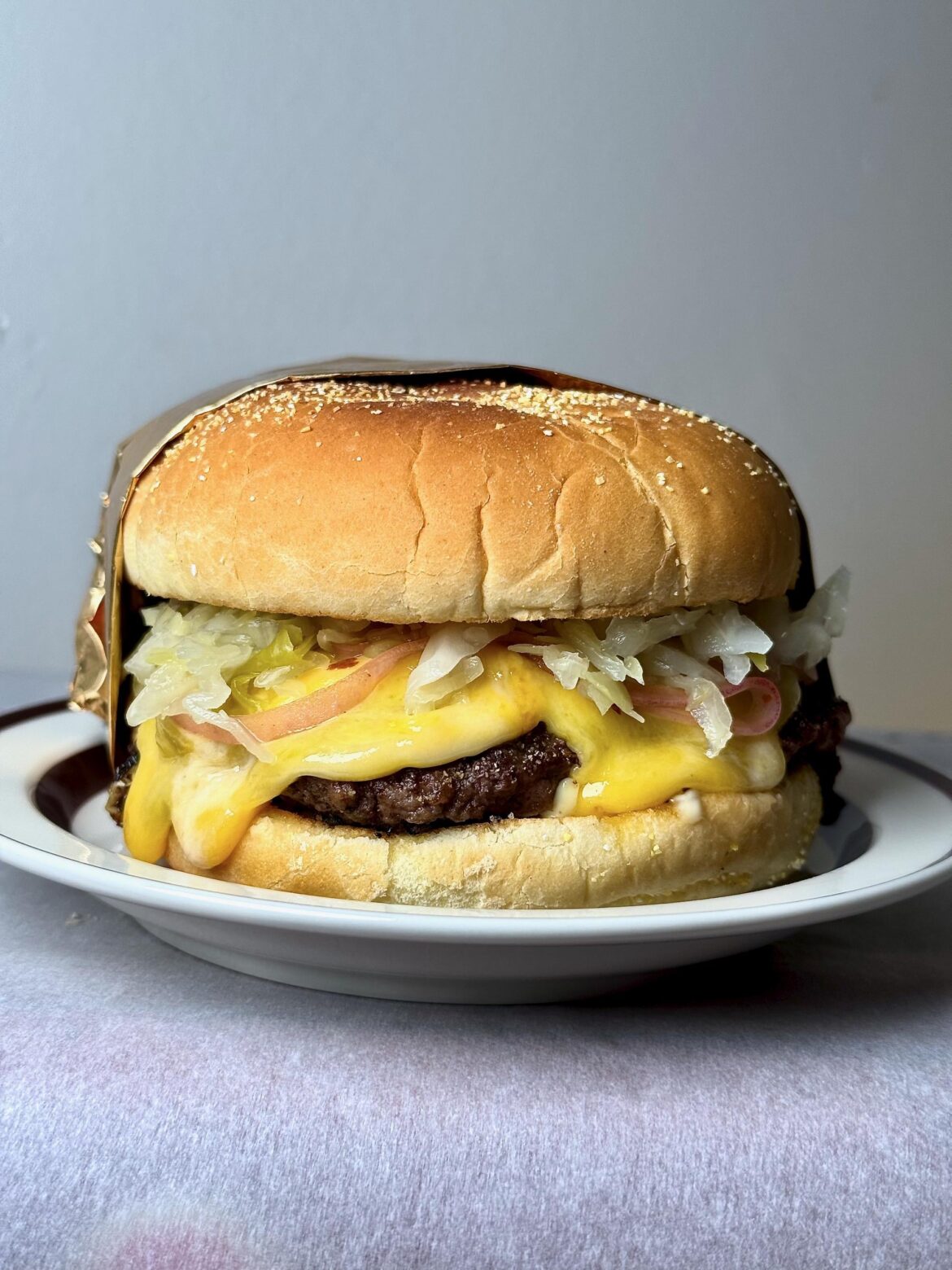 [homemade] 1/3lb burger with steamed Colby Jack, PRO, and fresh kraut. Kaiser bun.
