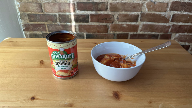 Cheese Ravioli in Tomato Sauce with spoon on wooden table