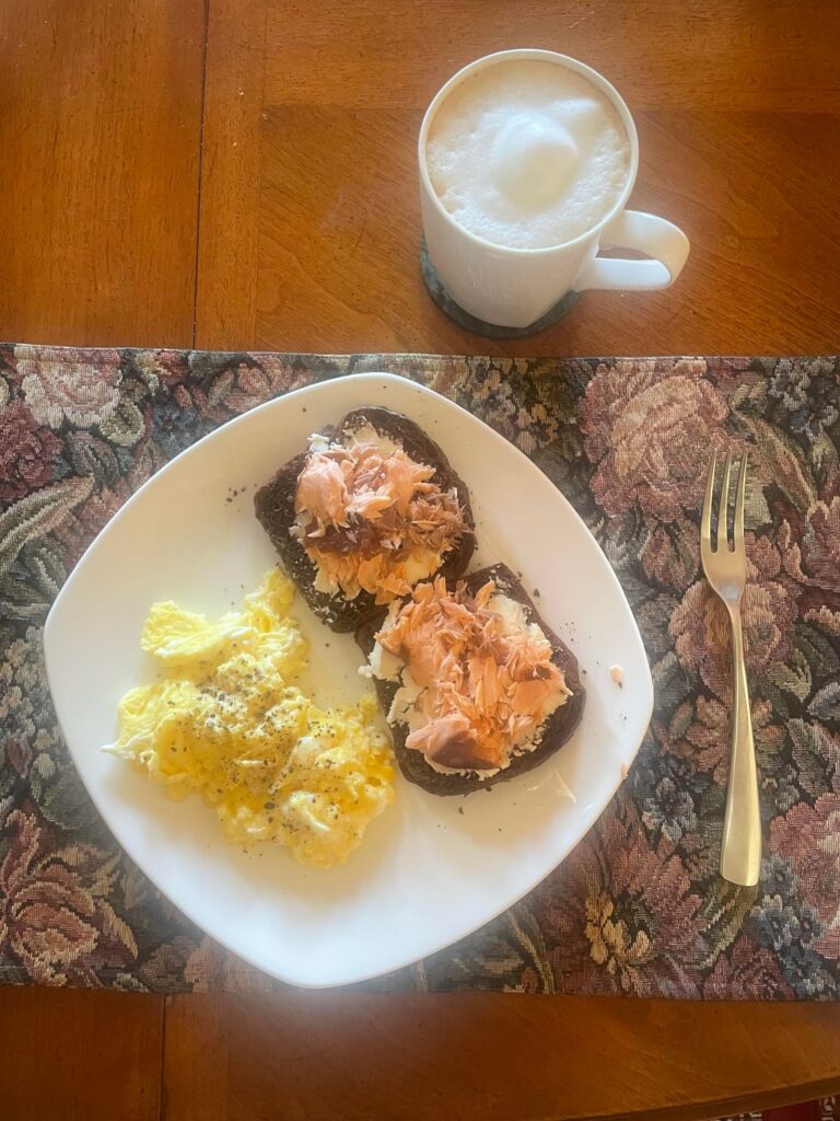 Homemade Russian black bread with cream cheese, smoked salmon and scrambled eggs