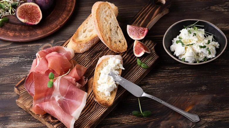 Italian meal of cheese, figs, and prosciutto