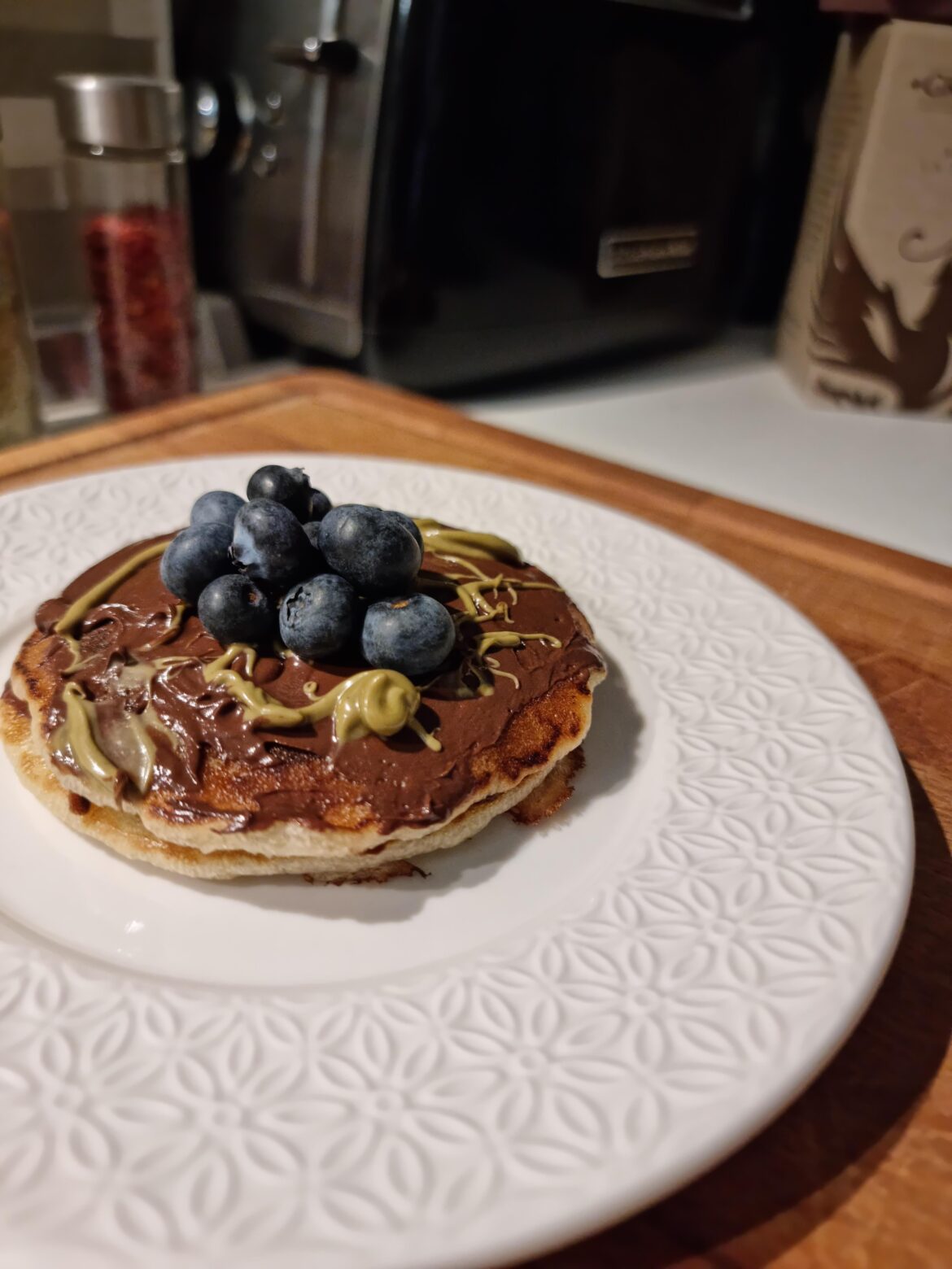 Pancakes made with only oatmeal, yogurt, and eggs. Topped with my homemade hazelnut spread, pistachio cream, and fresh blueberries.