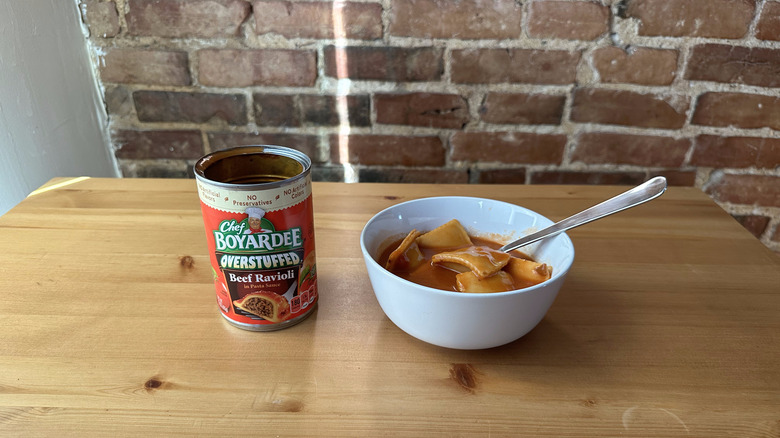 Overstuffed Beef Ravioli with spoon on wooden table